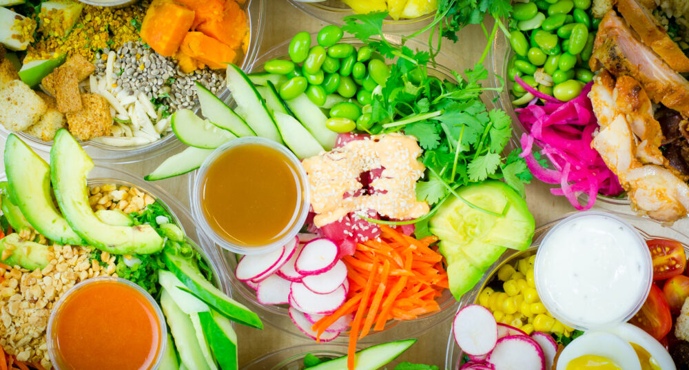 Bright colorful grain bowls and salads on a table at Original Grain in Syracuse, New York