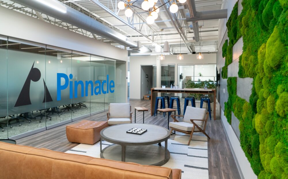 Modern lighting, branded glass panels, contemporary furniture and natural environmental finishes in Pinnacle Investments' comfortable client waiting area