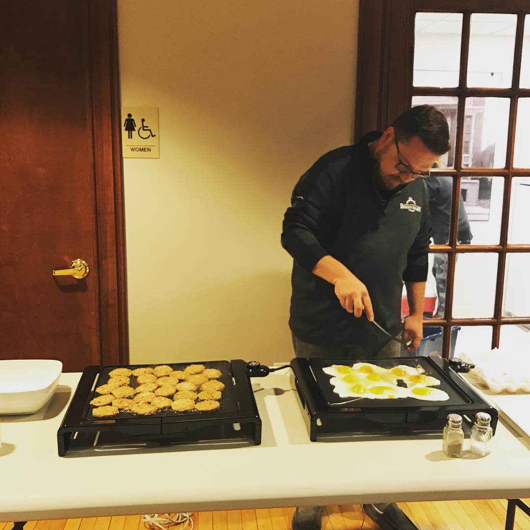 Travis cooking eggs at the Brand Bash