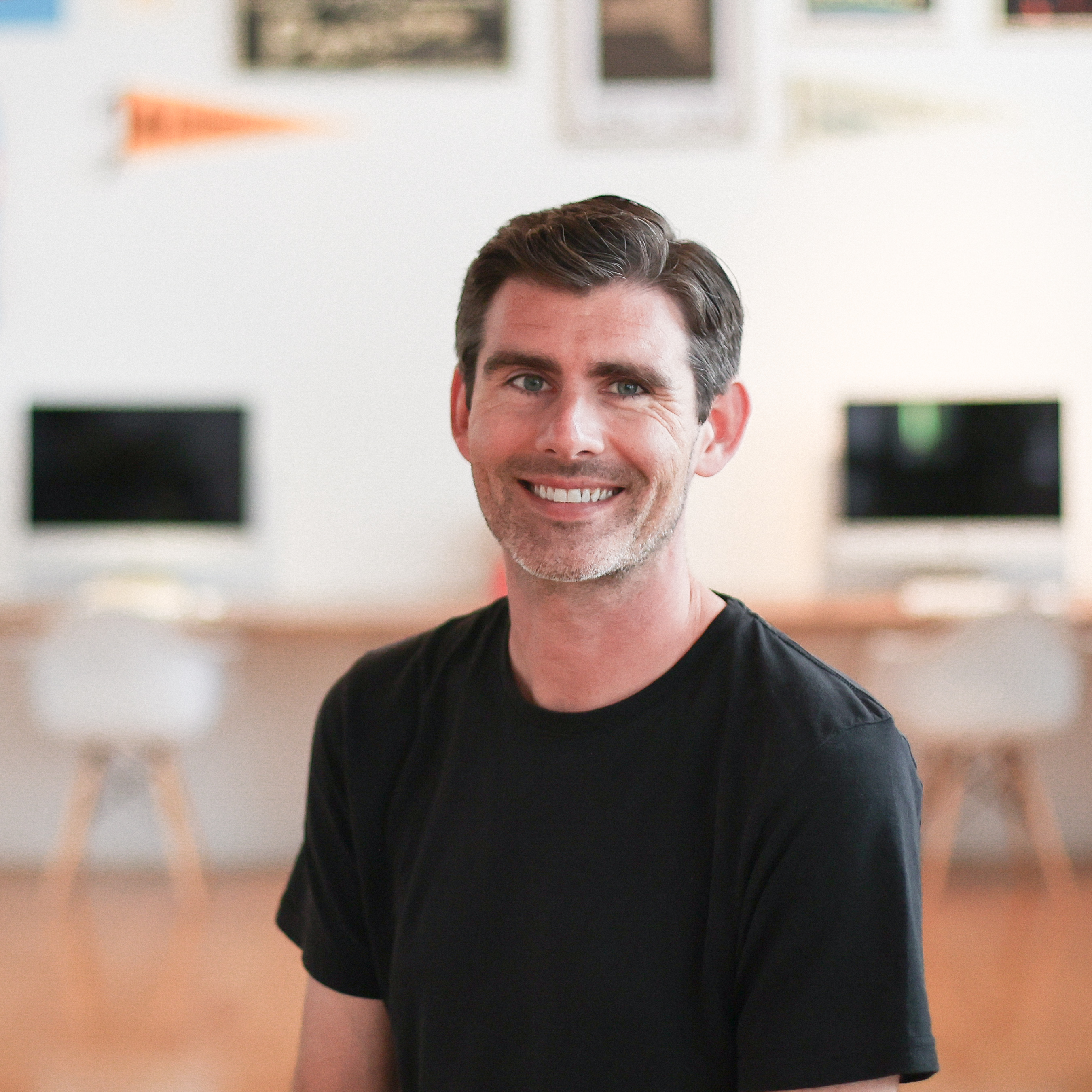 Andy Orr in sitting in a brightly lit studio