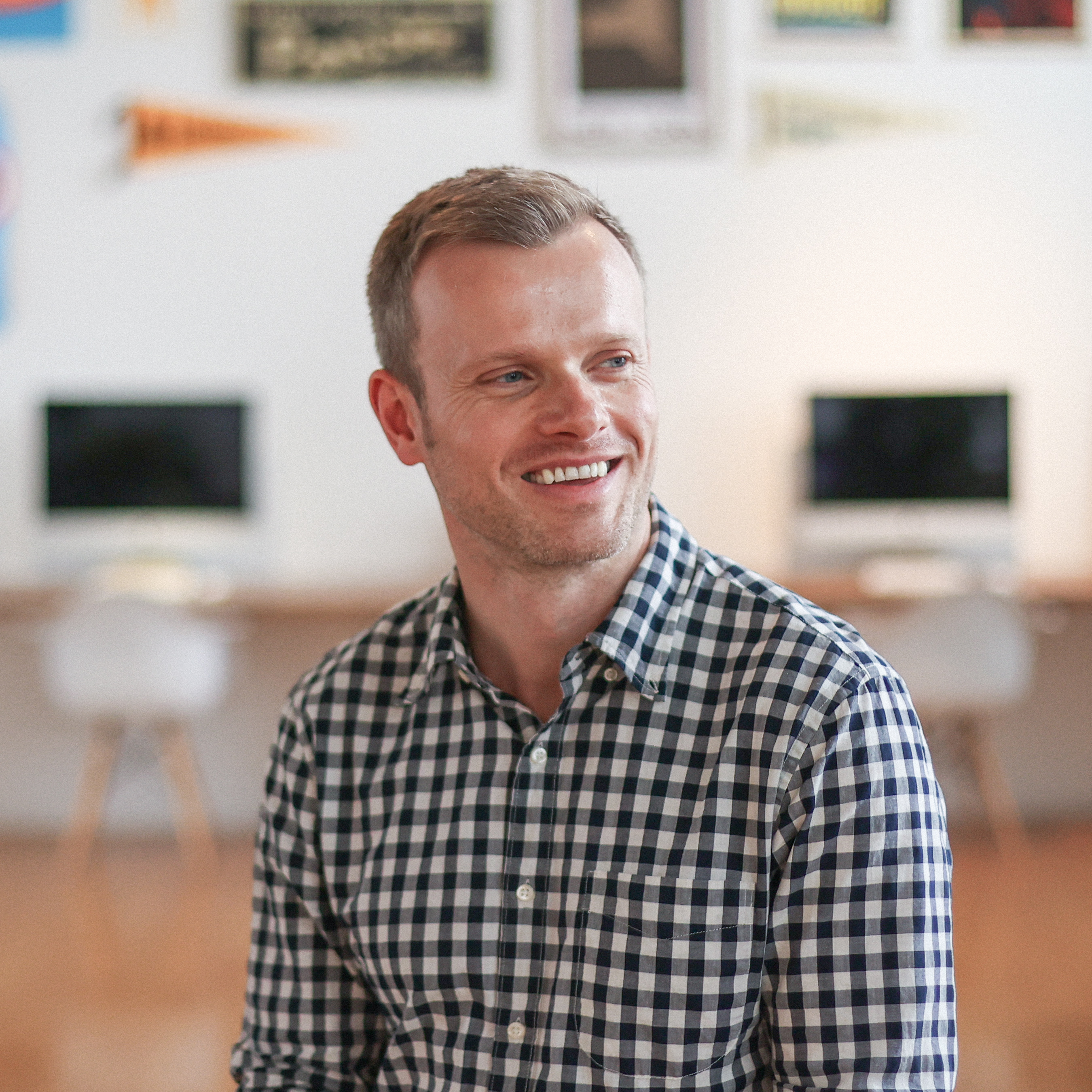 Colin Brady sitting in a brightly lit studio